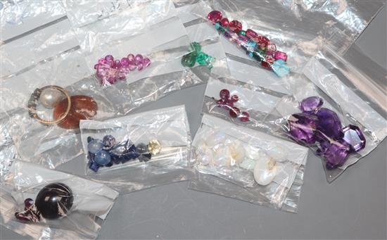 A collection of assorted unmounted gem stones, including white opal, amethyst, turquoise and citrine.